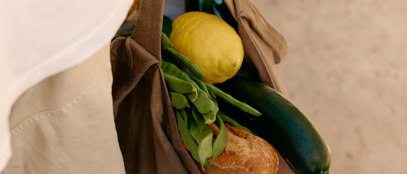 Einkaufstasche mit Zitrone, Bohnen, Zucchetti und Brot